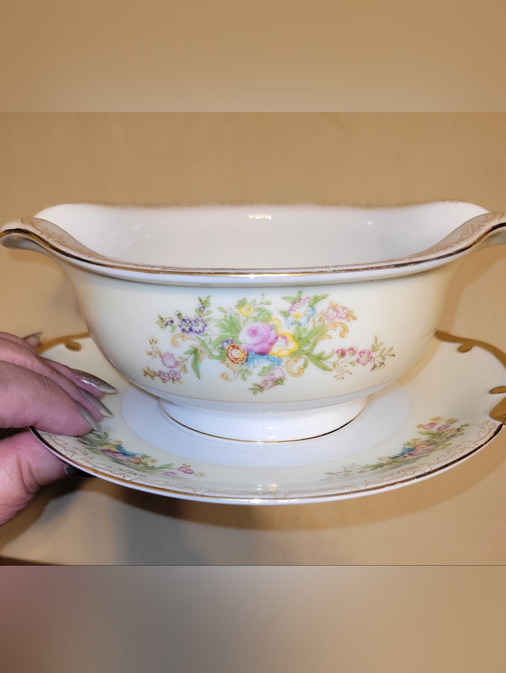 Meito China Hand Painted Porcelain Floral Gravy Boat with Attached Saucer.